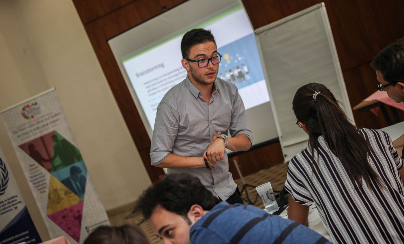 A trainer presenting in front of a screen