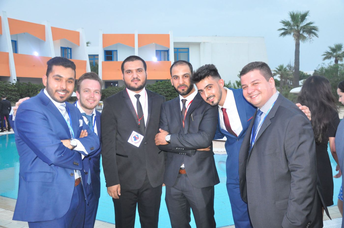 Participants together by the pool in the evening