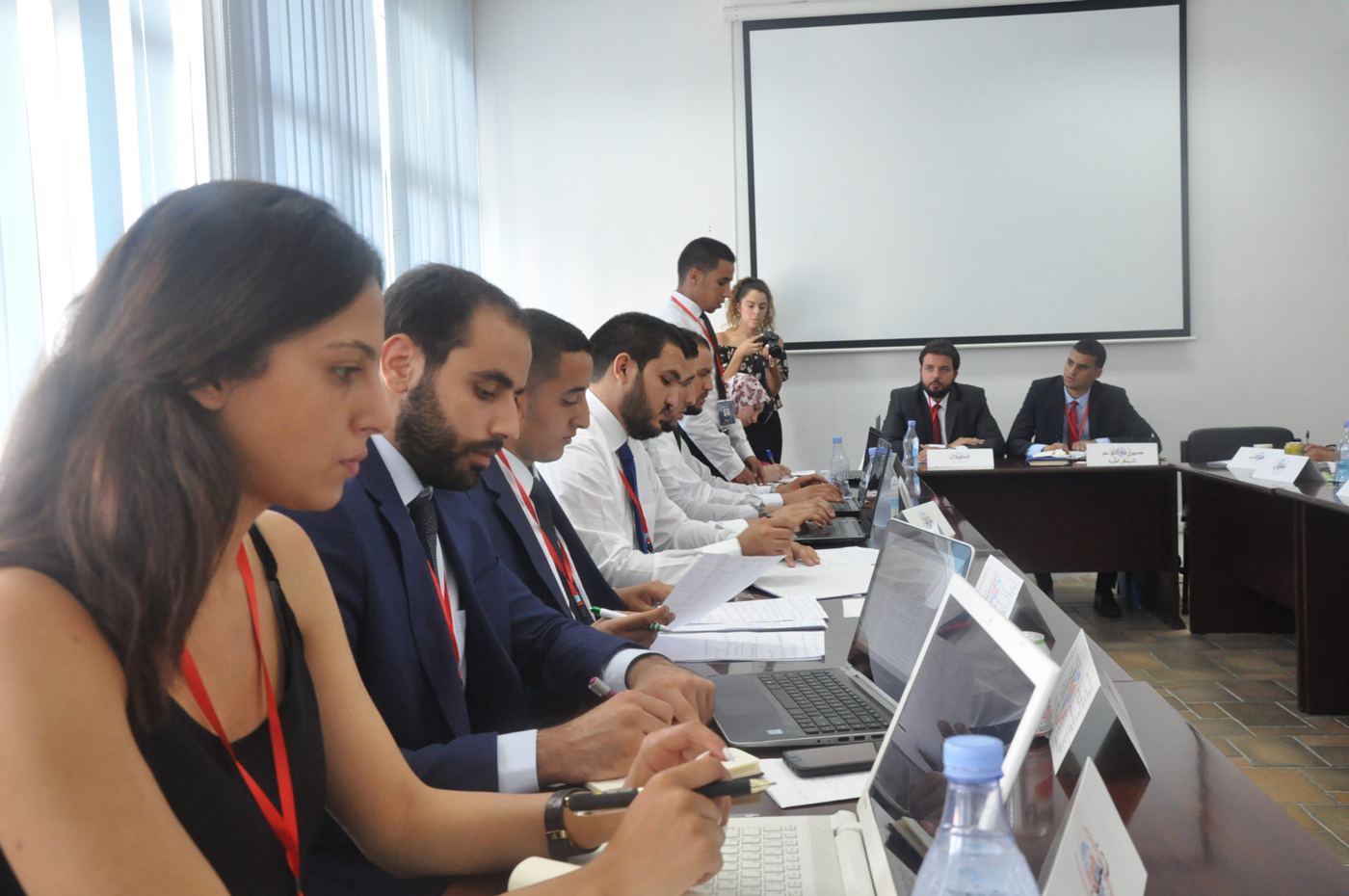 Participants negotiating around a conference table