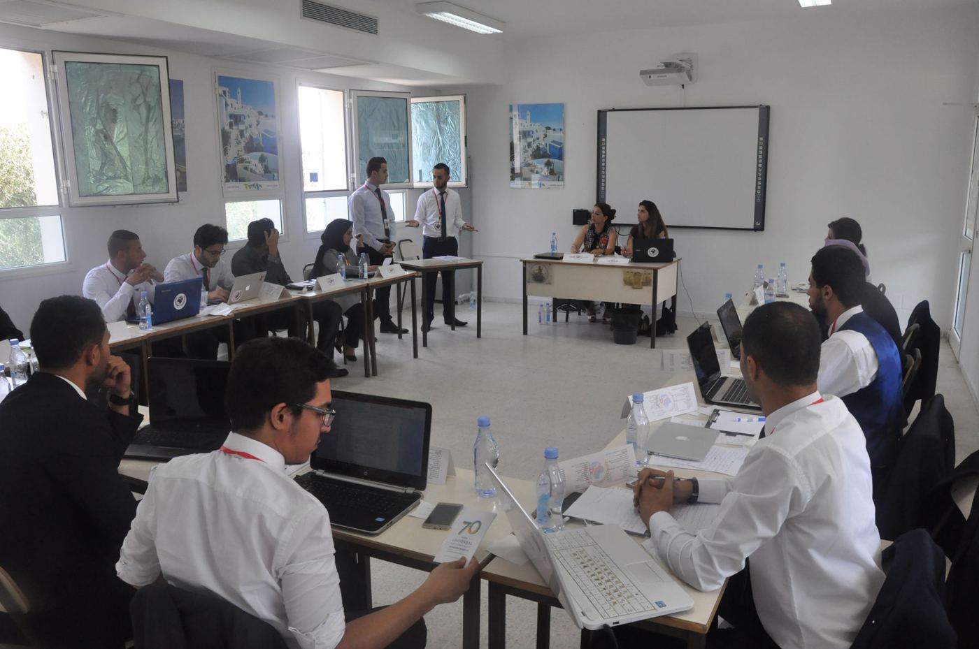 Participants working at laptops in the training room