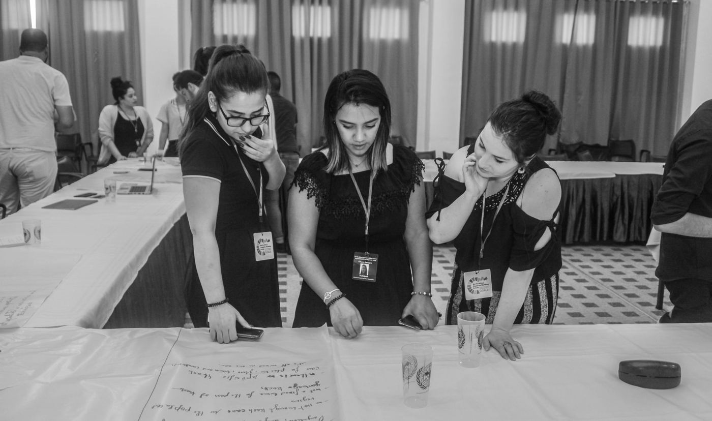 Participants analysing material at a workshop table